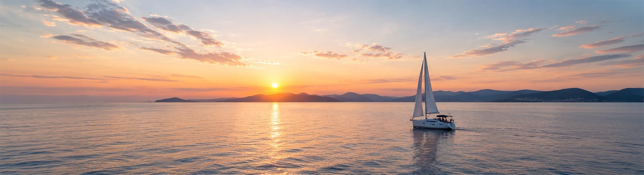 Sailboat on a calm sea at sunset